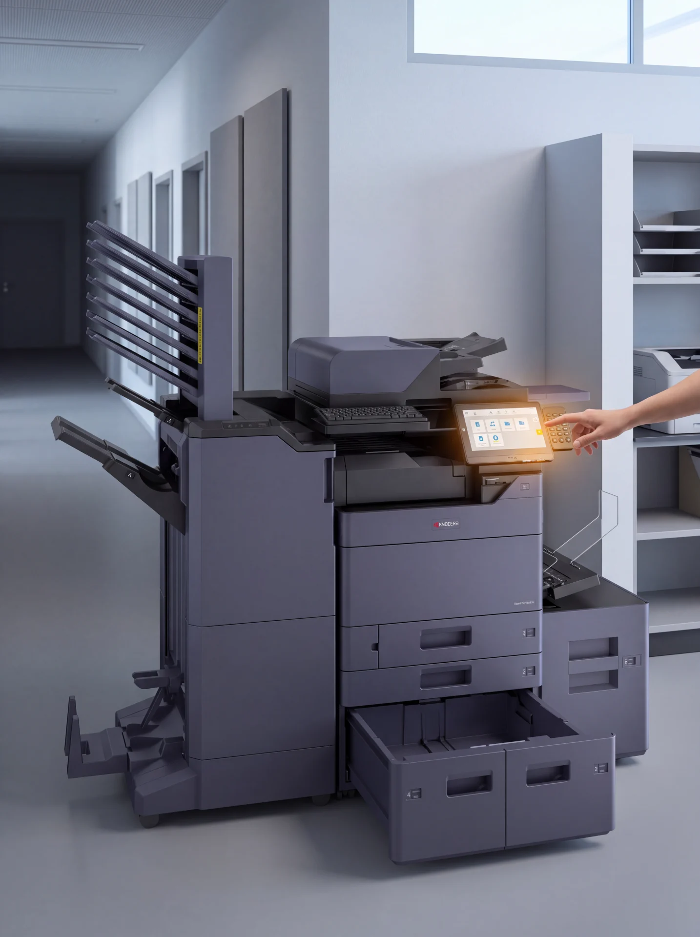 A hand at the control panel of a multifunction printer with an empty output tray, waiting for the sender to release the job.