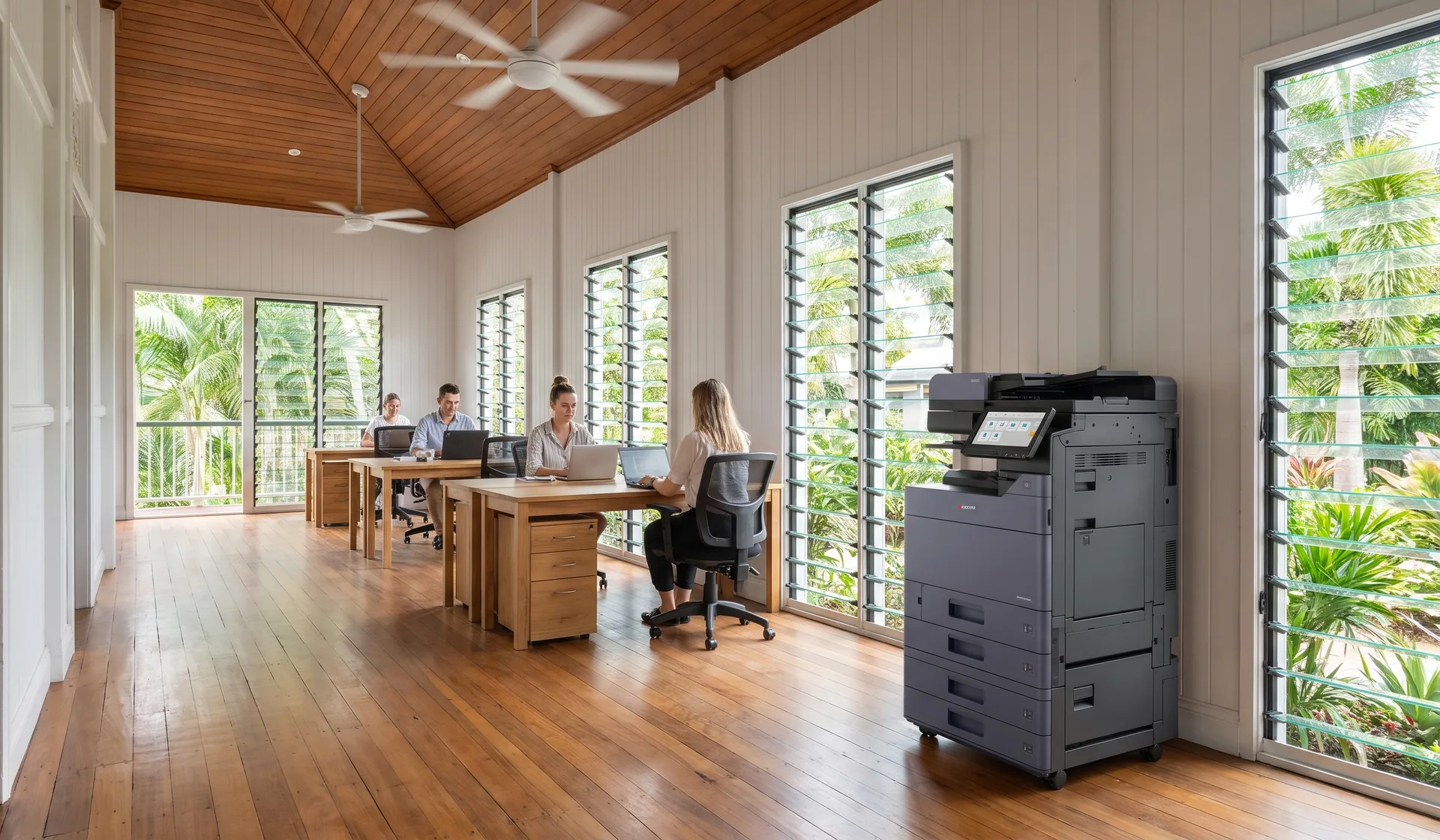 Kyocera multifunction printer in an open plan Cairns office inside a converted timber Queenslander with louvre windows and ceiling fans