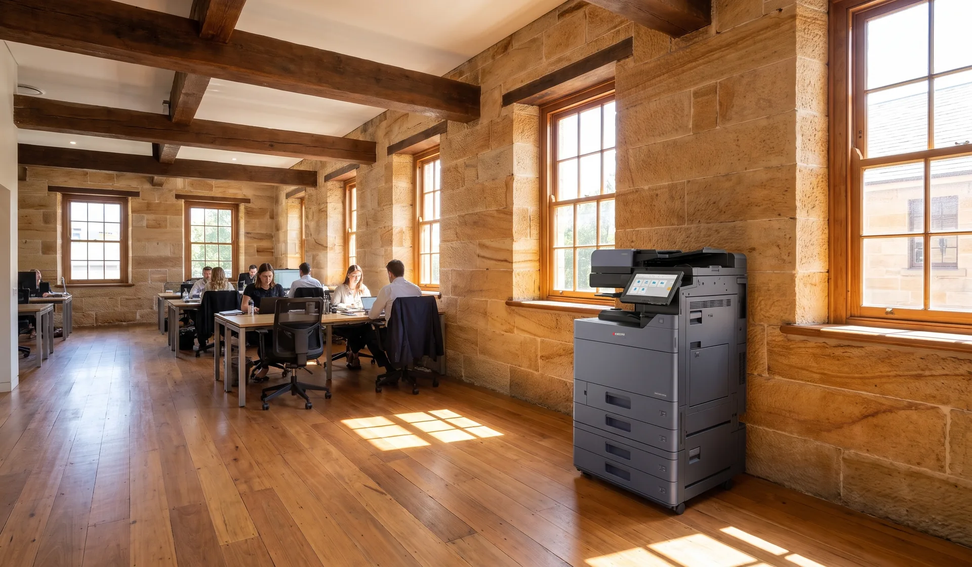 Kyocera multifunction printer in an open plan Parramatta office inside a restored sandstone heritage building with timber beams and sash windows