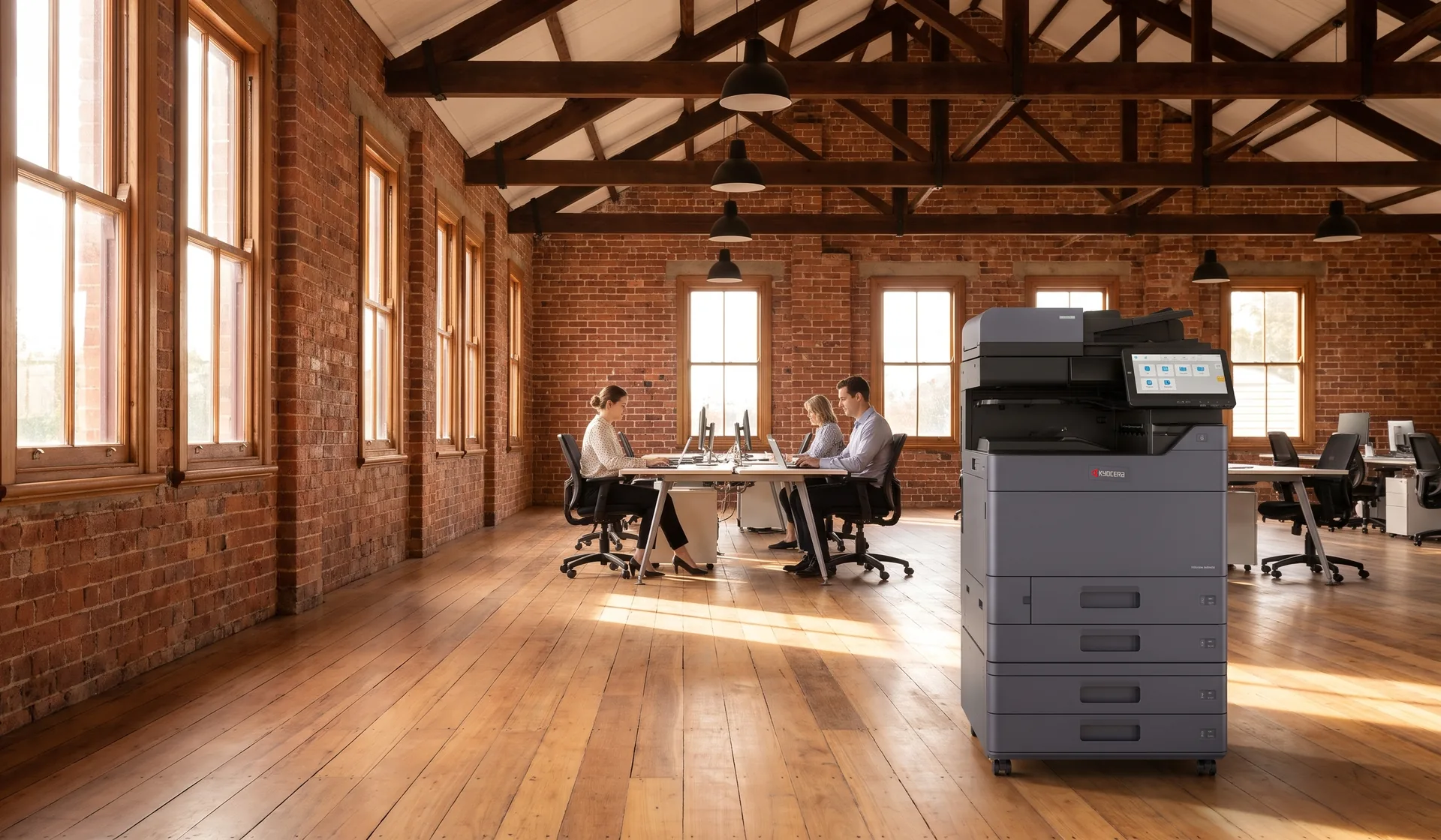 Kyocera multifunction printer in an open plan Toowoomba office inside a restored red brick warehouse with timber trusses