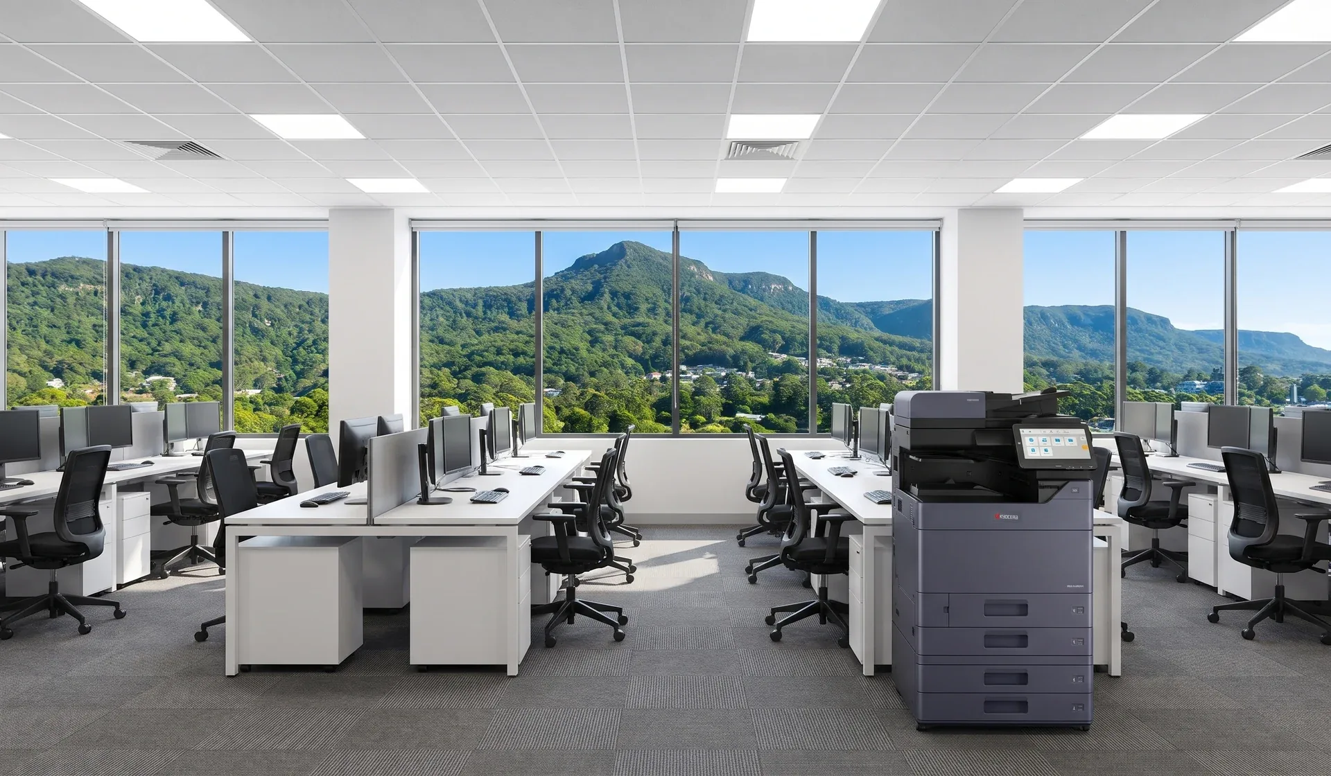 Kyocera multifunction printer in an open plan Wollongong office with the Illawarra escarpment through the windows